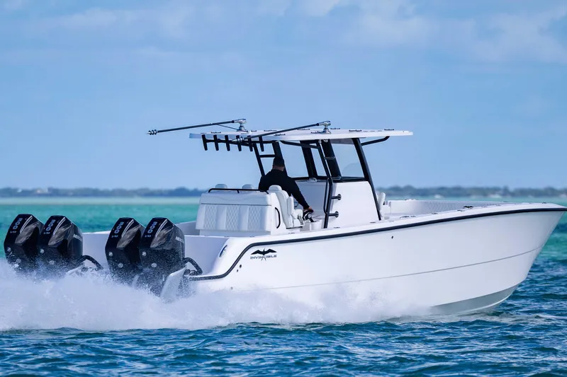  Yacht Photos Pics 2025 Invincible 35 Catamaran speeding on open water, showcasing powerful engines and sleek design.