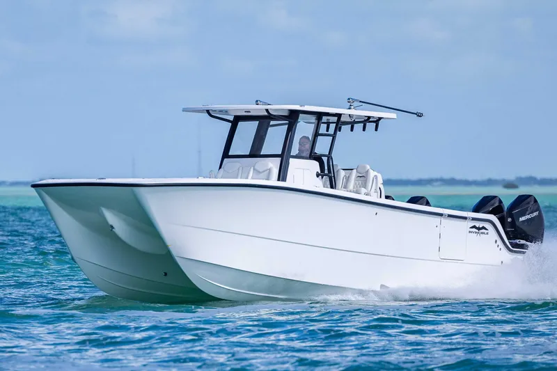  Yacht Photos Pics 2025 Invincible 35 Catamaran cruising on blue ocean waters.