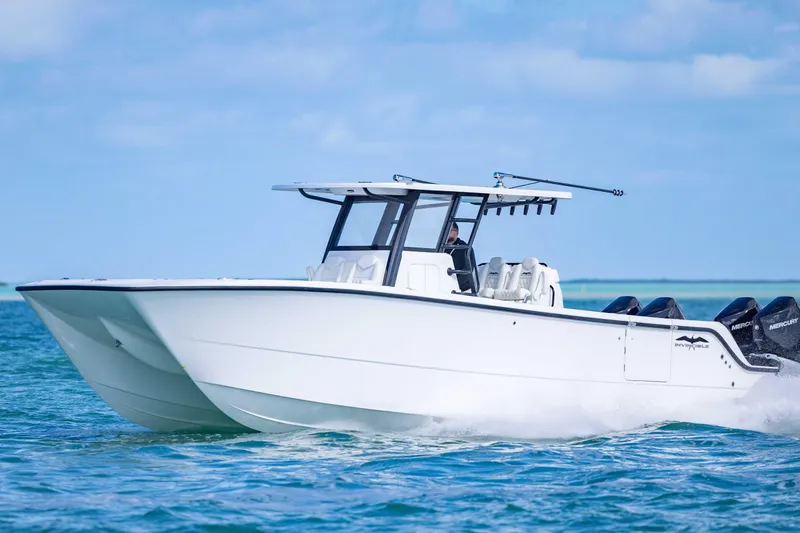  Yacht Photos Pics 2025 Invincible 35 Catamaran cruising on blue ocean waters.