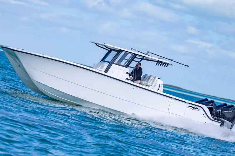  Yacht Photos Pics 2025 Invincible 35 Catamaran cruising on open water under a clear sky.