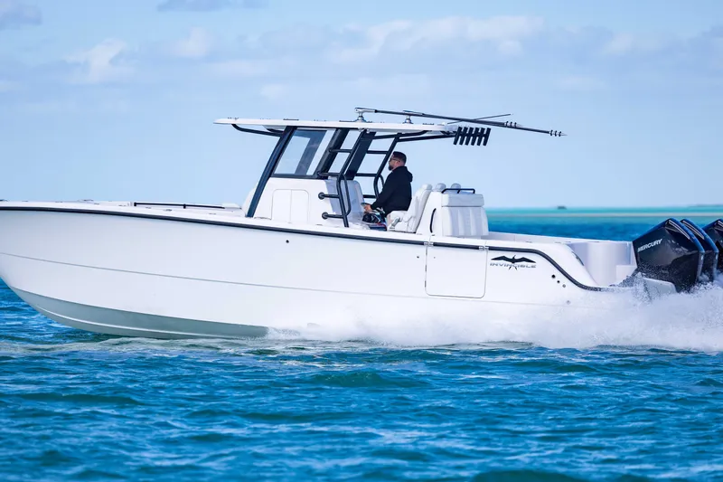  Yacht Photos Pics 2025 Invincible 35 Catamaran cruising on blue ocean waters.