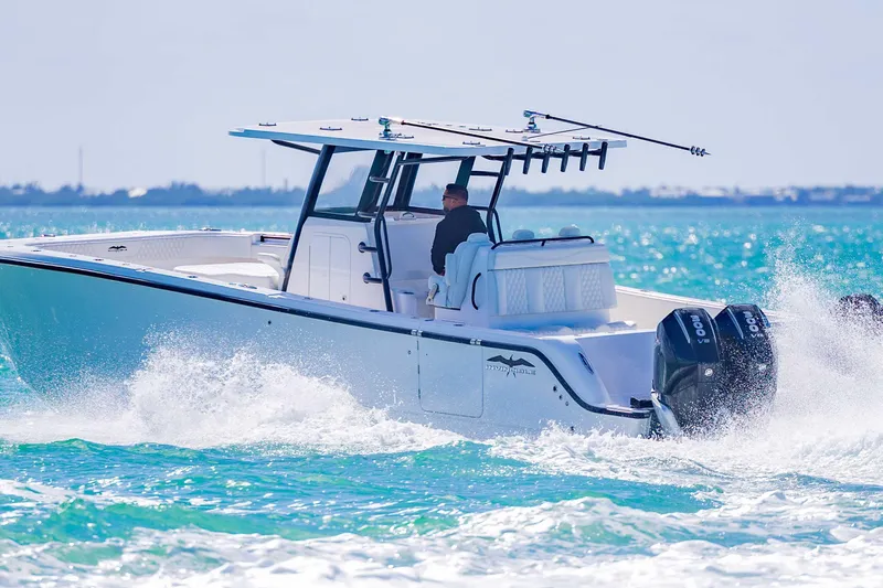  Yacht Photos Pics 2025 Invincible 35 Catamaran cruising on turquoise waters, showcasing sleek design and powerful engines.