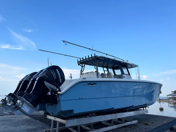  Yacht Photos Pics 2022 Invincible 40 Catamaran with Mercury engines on display by the water.