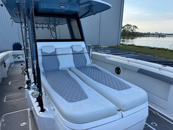  Yacht Photos Pics 2022 Invincible 40 Catamaran with luxurious seating, docked by a serene waterfront.