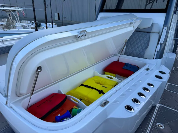  Yacht Photos Pics Open storage compartment on 2022 Invincible 40 Catamaran with safety gear and emergency kit.