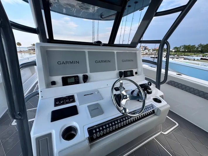  Yacht Photos Pics Helm of 2022 Invincible 40 Catamaran featuring Garmin displays and Mercury controls.