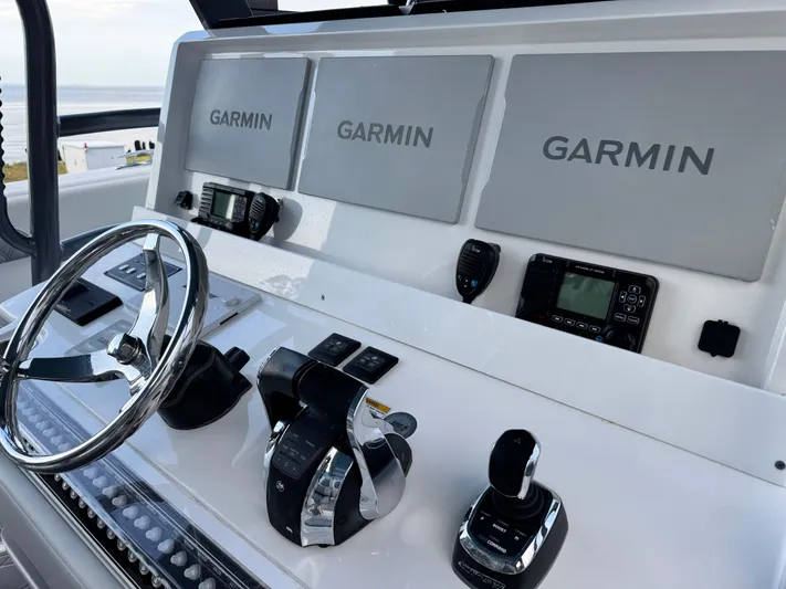  Yacht Photos Pics Control panel of 2022 Invincible 40 Catamaran with Garmin displays and steering wheel.
