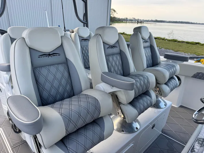  Yacht Photos Pics Luxurious seating on 2022 Invincible 40 Catamaran, featuring elegant gray and white upholstery.