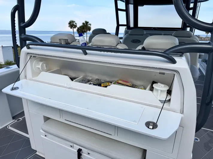  Yacht Photos Pics Open storage compartment on 2022 Invincible 40 Catamaran, featuring fishing gear and accessories.