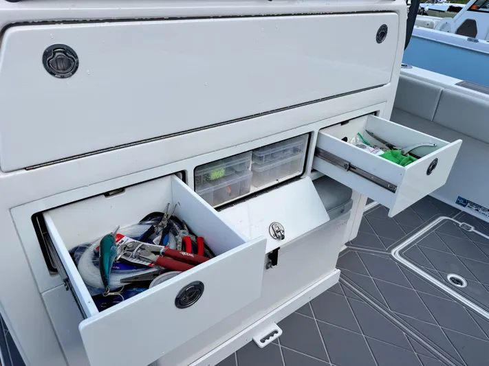  Yacht Photos Pics Fishing gear storage on 2022 Invincible 40 Catamaran, featuring organized drawers and tackle boxes.