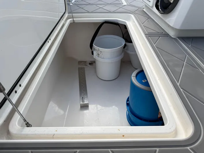  Yacht Photos Pics Storage compartment on 2022 Invincible 40 Catamaran with buckets and a ruler.