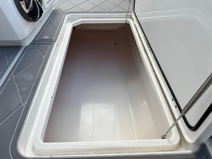  Yacht Photos Pics Open storage compartment on 2022 Invincible 40 Catamaran boat, showcasing interior space.