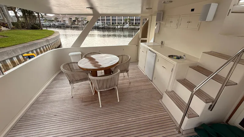 Destination Yacht Photos Pics Outdoor deck of 1995 Ocean Alexander 546 yacht with table, chairs, and kitchenette.