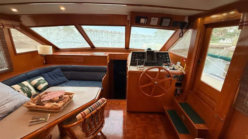 Destination Yacht Photos Pics Interior of 1995 Ocean Alexander 546 yacht with helm, seating, and wooden accents.
