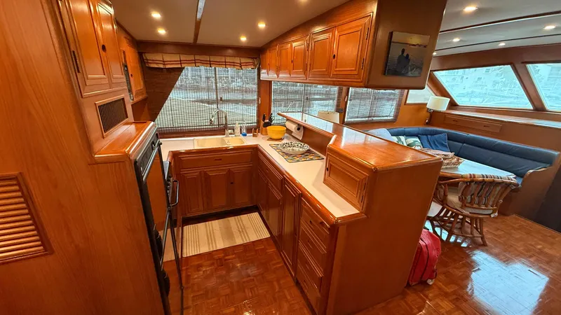 Destination Yacht Photos Pics Luxurious 1995 Ocean Alexander 546 yacht interior with wooden cabinetry and spacious seating area.