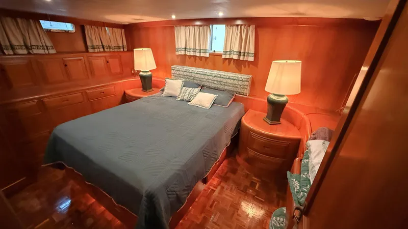 Destination Yacht Photos Pics Luxurious 1995 Ocean Alexander 546 yacht bedroom with wood paneling and elegant decor.