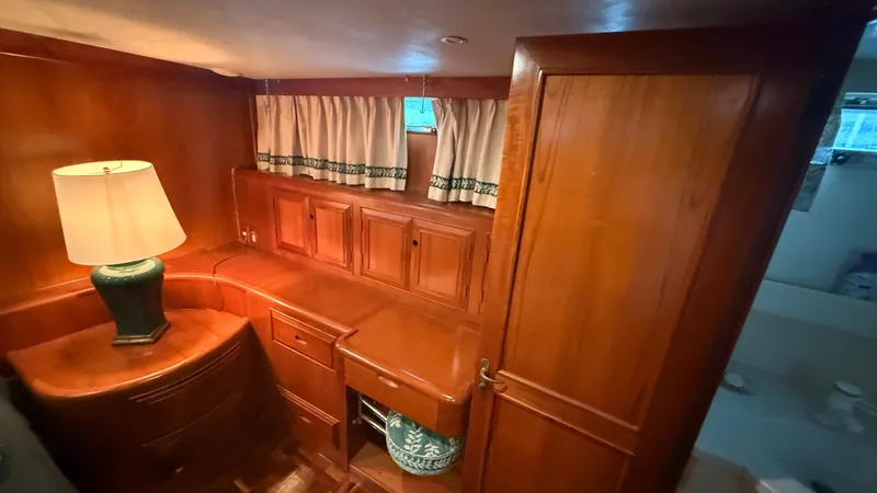 Destination Yacht Photos Pics Luxurious wooden interior of 1995 Ocean Alexander 546 yacht cabin with lamp and storage.