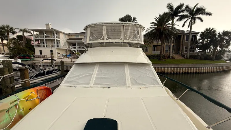 Destination Yacht Photos Pics 1995 Ocean Alexander 546 yacht docked near waterfront homes and palm trees.