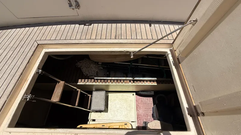 Destination Yacht Photos Pics Open hatch on 1995 Ocean Alexander 546 yacht, revealing storage compartment and ladder.