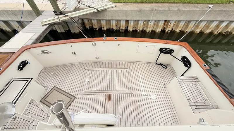 Destination Yacht Photos Pics Spacious deck of 1995 Ocean Alexander 546 yacht with wooden flooring and dock view.