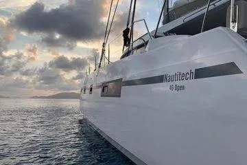 Susie Sea Yacht Photos Pics 2019 Nautitech 46 Open catamaran sailing at sunset on calm waters.