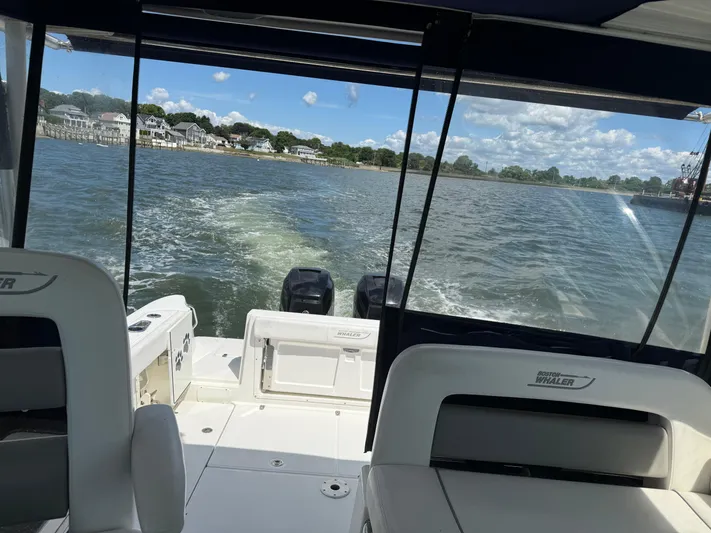 Fortunate Son Yacht Photos Pics Boston Whaler 315 Conquest 2013 cruising on a sunny day with scenic waterfront views.