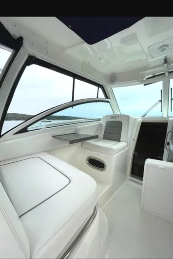 Fortunate Son Yacht Photos Pics 2013 Boston Whaler 315 Conquest interior with seating and table, showcasing modern design.