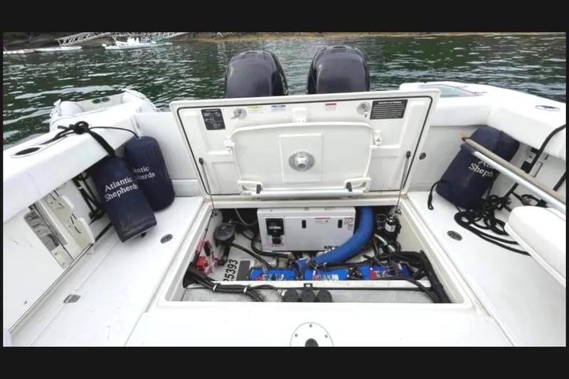 Fortunate Son Yacht Photos Pics 2013 Boston Whaler 315 Conquest engine compartment with open hatch, showcasing marine equipment.