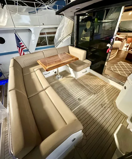 Perridice Yacht Photos Pics 2017 Sea Ray Sundancer 510 yacht with elegant outdoor seating and wooden table.