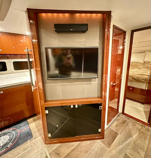 Perridice Yacht Photos Pics Interior of 2017 Sea Ray Sundancer 510 yacht with TV and wood cabinetry.