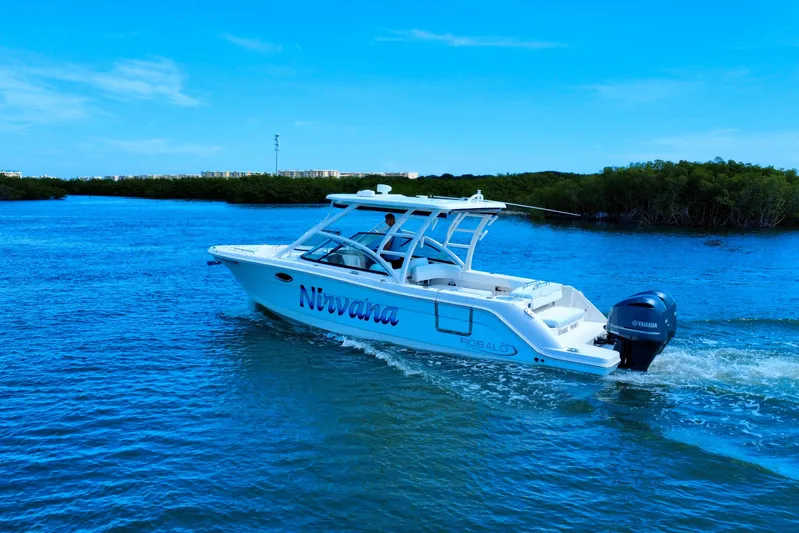  Yacht Photos Pics 2019 Robalo R317 Dual Console boat cruising on blue water, labeled "Nirvana."