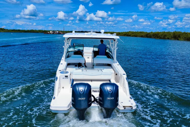  Yacht Photos Pics 2019 Robalo R317 Dual Console boat cruising on a sunny day with twin Yamaha engines.