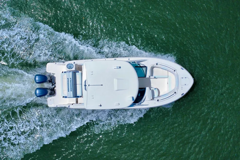  Yacht Photos Pics Overhead view of 2019 Robalo R317 Dual Console boat cruising on water.