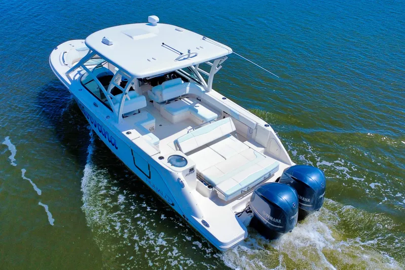  Yacht Photos Pics 2019 Robalo R317 Dual Console boat cruising on open water.