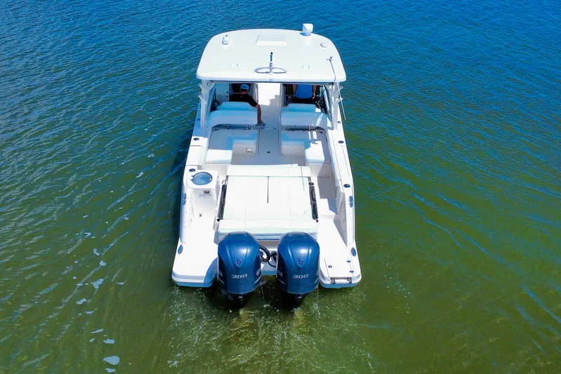  Yacht Photos Pics 2019 Robalo R317 Dual Console boat with twin engines on clear water.