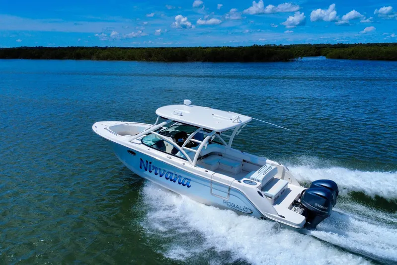  Yacht Photos Pics 2019 Robalo R317 Dual Console boat cruising on open water under a clear blue sky.