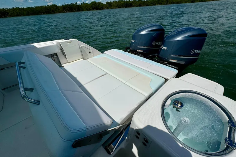  Yacht Photos Pics 2019 Robalo R317 Dual Console boat with Yamaha engines on a serene lake.