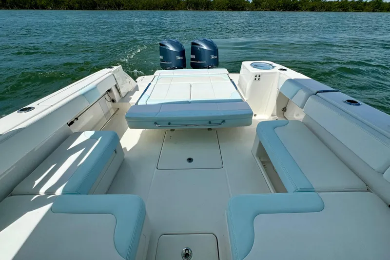  Yacht Photos Pics 2019 Robalo R317 Dual Console boat interior with seating and twin engines on water.