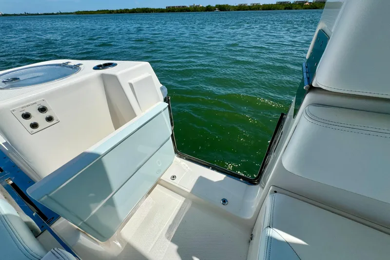  Yacht Photos Pics 2019 Robalo R317 Dual Console boat with open side door, overlooking calm water.
