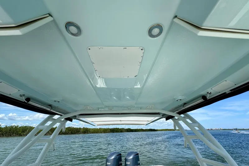  Yacht Photos Pics 2019 Robalo R317 Dual Console boat canopy view over water.