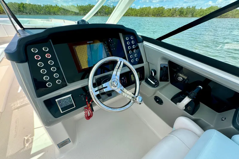 Yacht Photos Pics 2019 Robalo R317 Dual Console boat dashboard with steering wheel and control panel.