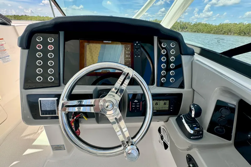  Yacht Photos Pics 2019 Robalo R317 Dual Console helm with steering wheel and control panel.
