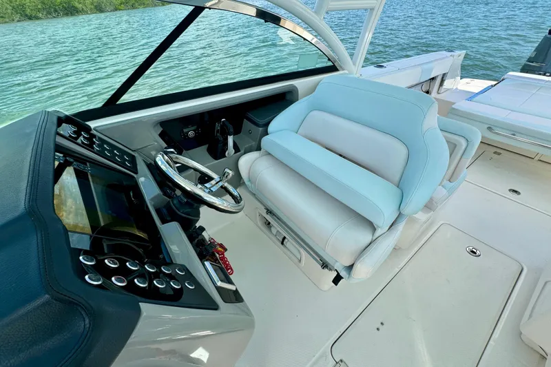  Yacht Photos Pics 2019 Robalo R317 Dual Console boat interior with steering wheel and seating.