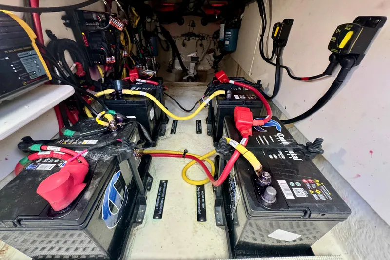  Yacht Photos Pics 2019 Robalo R317 Dual Console boat battery compartment with multiple connected batteries.