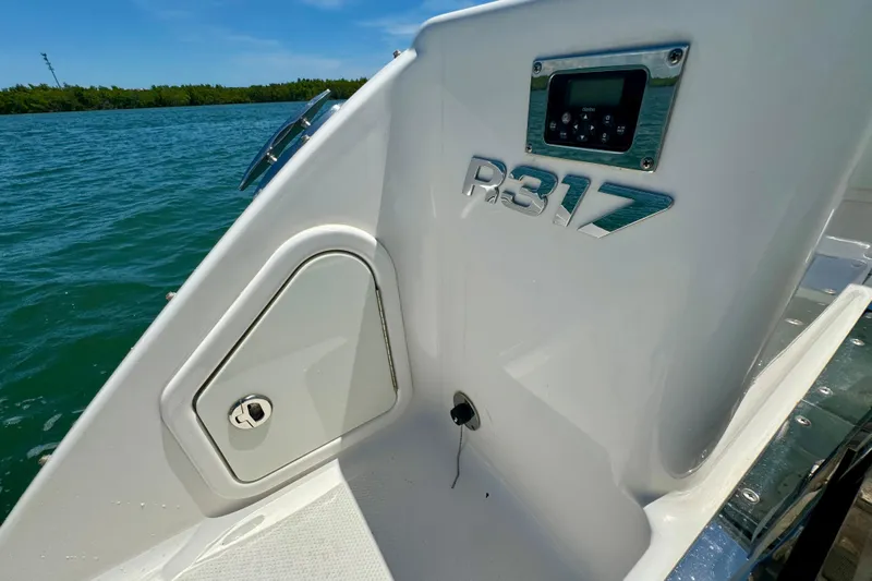  Yacht Photos Pics 2019 Robalo R317 Dual Console boat detail with control panel, docked by the water.
