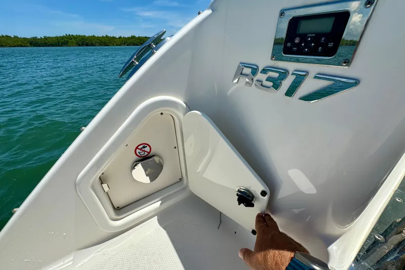  Yacht Photos Pics 2019 Robalo R317 Dual Console boat detail with control panel and storage compartment.