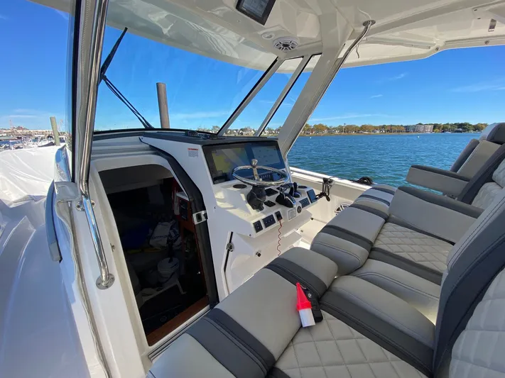  Yacht Photos Pics 2022 Pursuit 378S boat interior with luxurious seating and advanced navigation system.