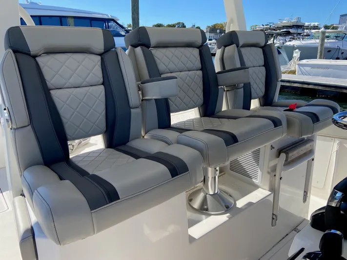  Yacht Photos Pics Luxurious seating on 2022 Pursuit 378S boat, featuring quilted upholstery and armrests.