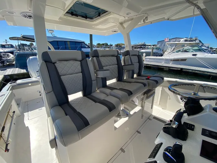  Yacht Photos Pics 2022 Pursuit 378S boat interior with luxurious seating and modern helm controls.
