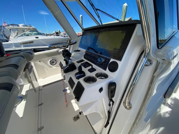  Yacht Photos Pics 2022 Pursuit 378S boat cockpit with advanced navigation controls and seating.